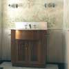 bathroom vanity unit backed by painted foliage