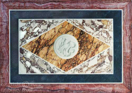 faux marble pietra dura inlay work depicting lions head in relief