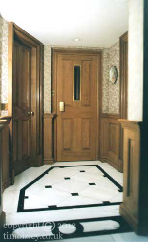 wood graining painted trompe l'oeil oak fielded panels on metal lift doors